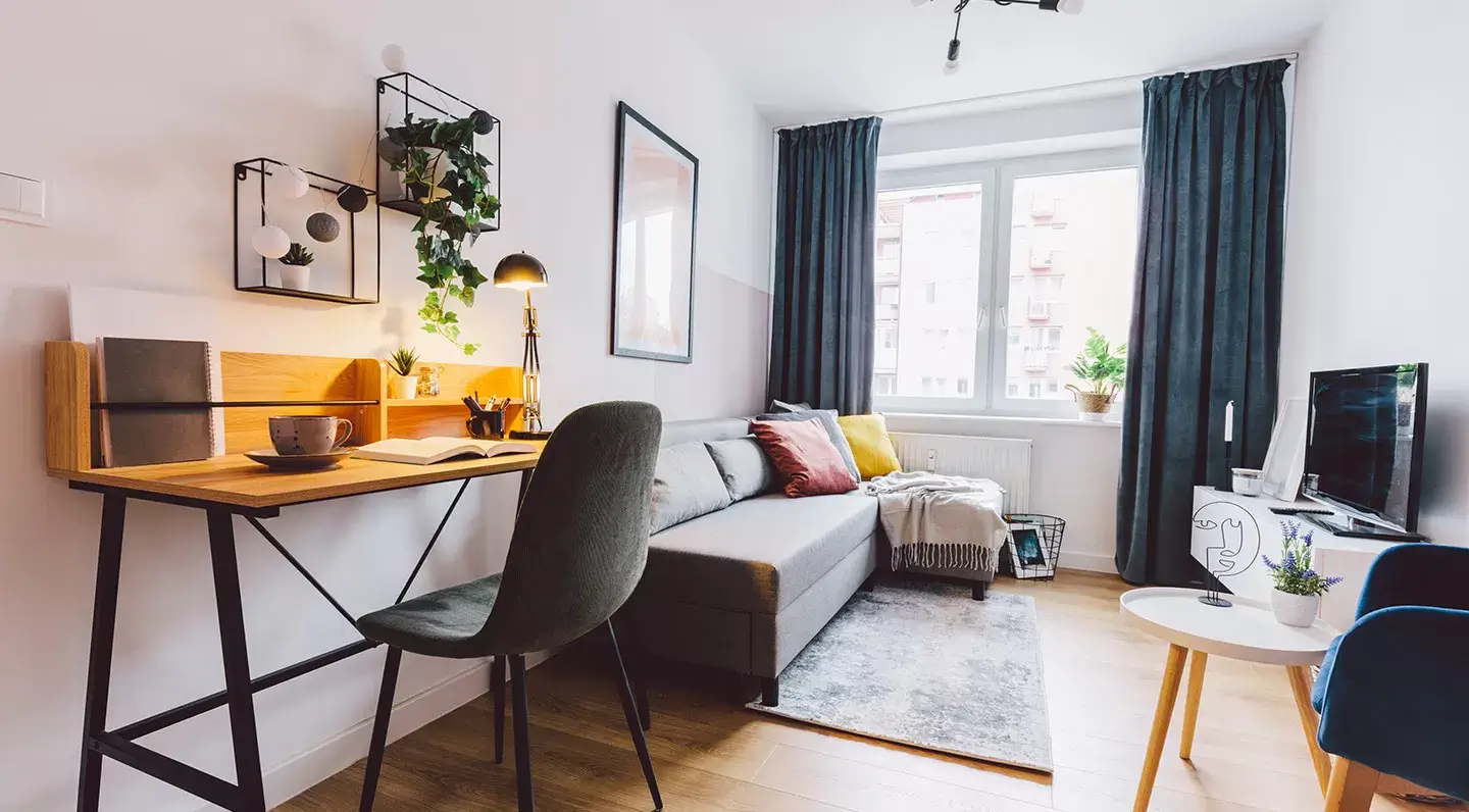 Compact living space lit by a fixed uPVC window