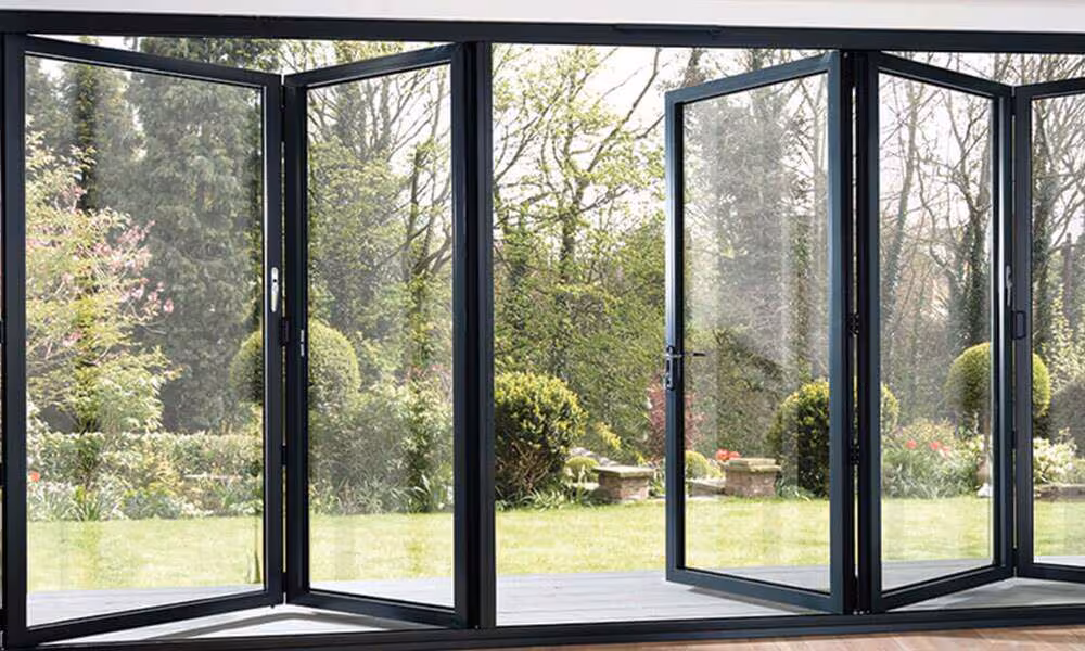 Dark-framed uPVC folding doors opening a living room to the outdoors