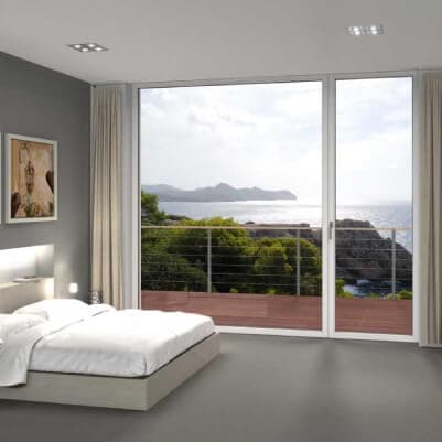 Bedroom with uPVC sliding doors opening to a sea view terrace