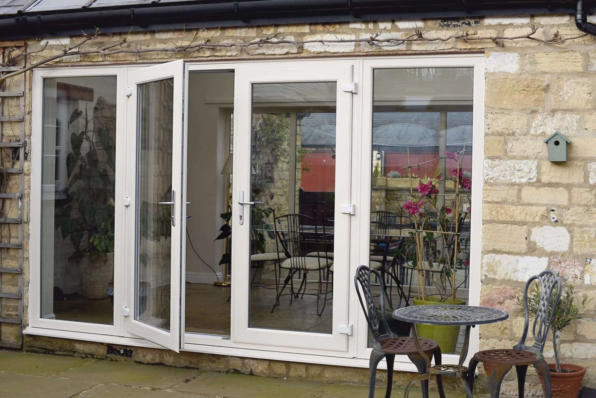 Black-framed uPVC French doors flanked by tall windows